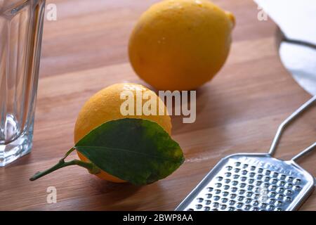 Lemons lying on the table. A few lemons lying in a cup. Lemons for making juice Stock Photo