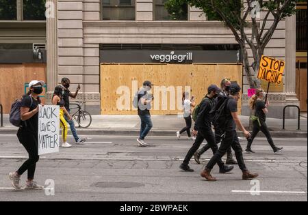 Los Angeles, USA, 3rd June, 2020. Protesters with signs march in honor of George Floyd Downtown. Credit: Jim Newberry/Alamy Live News. Stock Photo