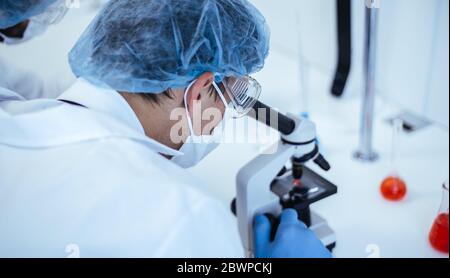 close up. scientist looking through a microscope. Stock Photo