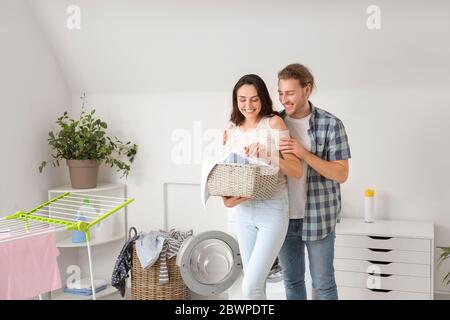 Happy young couple doing laundry at home Stock Photo