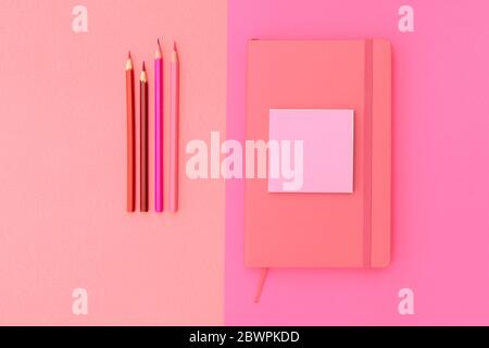 Pink notepad, pencil and marker on pink background. Flat lay. Concept office and back to school. Stock Photo