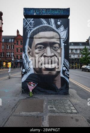 Manchester, UK. 02nd June, 2020. A tribute of flowers placed at the base a freshly painted mural of the late George Floyd, created by the artist AKSE.A mural of the late George Floyd, created in Manchester city centre. Credit: SOPA Images Limited/Alamy Live News Stock Photo