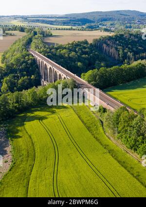 14 September 2017, Saxony, Göhren: With the Göhren Viaduct, the Leipzig-Chemnitz railway line crosses the Zwickauer Mulde. The railway bridge, originally 512 metres long and 68 metres high, is the third largest of these structures in Saxony. For years, only regional trains have been running on the only slightly electrified line between Leipzig and Chemnitz. The planned extension of the line will not begin until 2025 at the earliest. If conditions are favourable, the line could be double-tracked and electrified three years later. (Aerial photograph with drone) Photo: Jan Woitas/dpa-Zentralbild/ Stock Photo