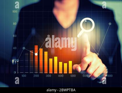 Businesswomen hand touching search engine optimization financial graph data and stock market digital graph chart on screen display. Digital marketing Stock Photo