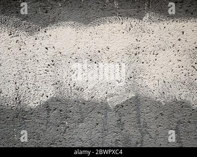 Grey plastered wall with white strip as creative brutal abstract background with copy space for your text. Real stucco pronounced texture. Selective Stock Photo