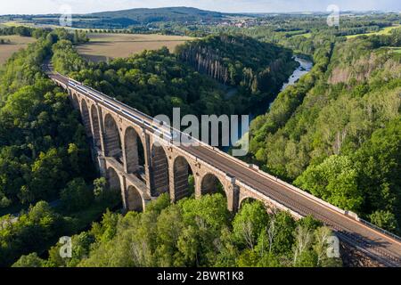 14 September 2017, Saxony, Göhren: With the Göhren Viaduct, the Leipzig-Chemnitz railway line crosses the Zwickauer Mulde. The railway bridge, originally 512 metres long and 68 metres high, is the third largest of these structures in Saxony. For years, only regional trains have been running on the only slightly electrified line between Leipzig and Chemnitz. The planned expansion of the line will not begin until 2025 at the earliest. If conditions are favourable, the line could be double-tracked and electric power could be available three years later. (Aerial photograph with drone) Photo: Jan W Stock Photo