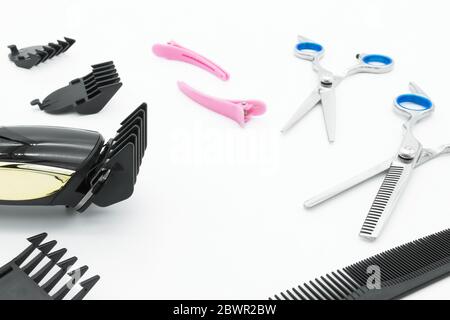 Hair scissors set hairdressing tools with cordless electric hair clipper are isolated on white background. Stock Photo