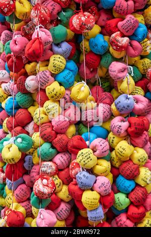 KYOTO, JAPAN - OCTOBER 18, 2019:  Kukurizaru, the ball-shaped talisman, made of colorful cloth with the wishes of worshippers, representing the good f Stock Photo