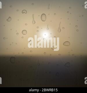 Abstract sunset with defocused lights. View through glass covered with drops. Vector eps10 Stock Vector