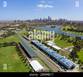Melbourne Australia February 4th 2020 : Aerial view of buildings on the Albert Park F1 Grand Prix circuit with the lake and city of Melbourne in the b