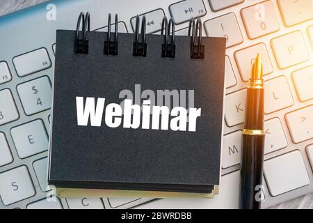 WEBINAR text with fountain pen and keyboard. Business and technology concept Stock Photo