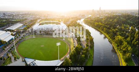 Melbourne Australia February 2nd 2020 : Aerial panoramic view in golden warm dawn light of the AAMI Stadium and rowers on the Yarra River in Melbourne Stock Photo