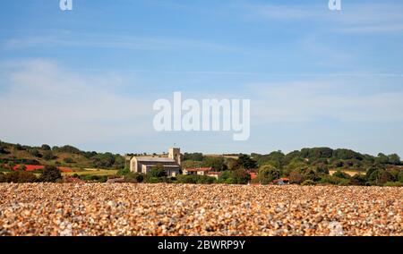 A view from the sea side of the shingle ridge towards the church and village of Salthouse, Norfolk, England, United Kingdom, Europe. Stock Photo