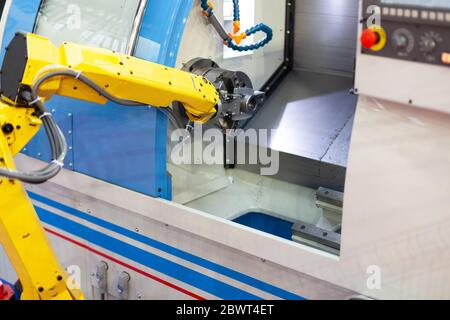Robotic arm with CNC lathe machine Stock Photo