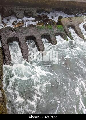 Blurred sea background. Beauty and strength of a deep blue sea. Sea waves washing an old abandoned concrete slab on the seashore. Stock Photo