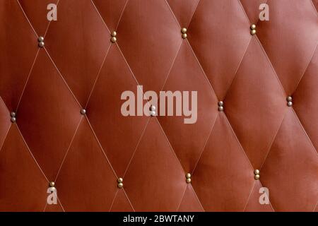 Soviet soft brown dermantine front door with a banner of fishing line and nails - full frame background and texture Stock Photo