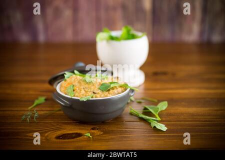 boiled bulgur groats with vegetables and herbs Stock Photo