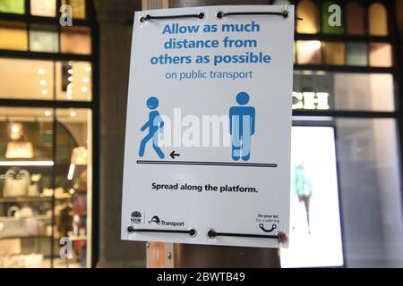 Notice advising people to keep as much distance as possible from one another during the coronavirus (Covid-19) pandemic at a light rail stop in Sydney Stock Photo
