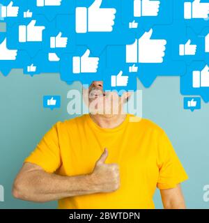 What's in your head. Senior man with big speech bubbles on his head like a hairstyle made of likes. Creative contemporary artwork. Daily thoughts, sales, addiction of social media, communication. Stock Photo
