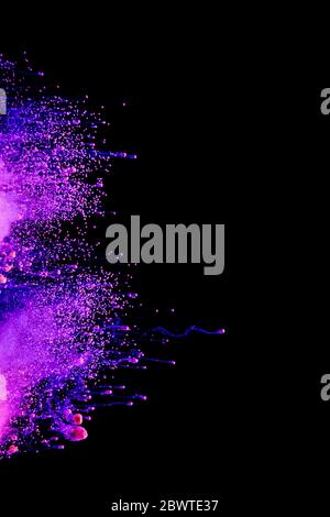 Abstract colored dust explosion on a black background.abstract powder splatted background, Freeze motion of color powder exploding/throwing color powd Stock Photo