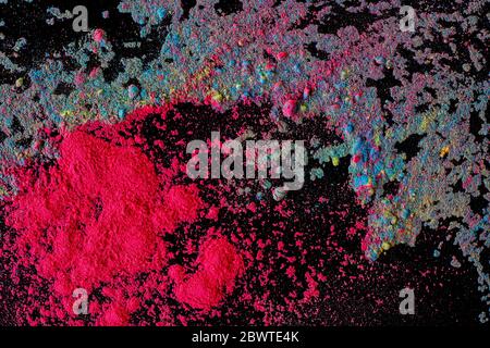 Abstract colored dust explosion on a black background.abstract powder splatted background, Freeze motion of color powder exploding/throwing color powd Stock Photo