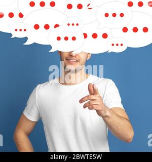 What's in your head. Young man with big speech bubbles on his head like a hairstyle made of thoughts. Creative contemporary artwork. Daily thoughts inside become visible and reflected outside. Stock Photo