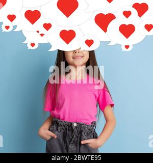 What's in your head. Little girl with big speech bubbles on her head like a hairstyle made of hearts. Creative contemporary artwork. Thoughts, inspiration, falling in love, addiction of social media. Stock Photo