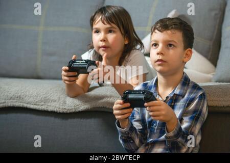 kids playing console games durring covid 19 outbreak Stock Photo