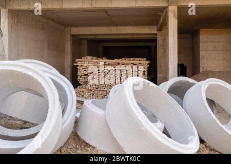 House under construction with timber and concrete pipes. Stock Photo