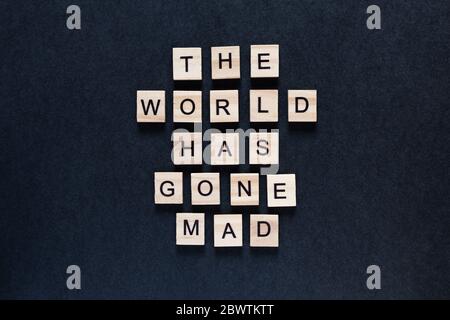 the world has gone mad an inscription on a black background Stock Photo