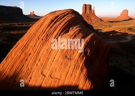 USA, Sandstone rock formation in Monument Valley with Mittens in background Stock Photo