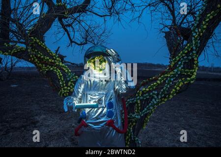 Spacewoman with a torch in the evening Stock Photo