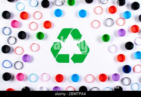 Colored plastic bottle caps with recycle symbol. World environment day or reuse, recycle concept. Stock Photo