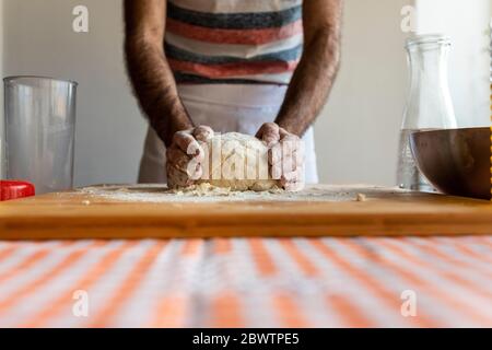 Crop view of man kneading dough Stock Photo