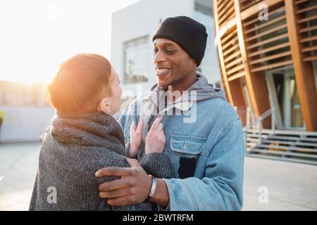 Happy young couple in the city at sunset Stock Photo