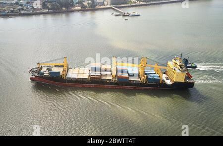 Mozambique, Maputo, Aerial view of container ship leaving city Stock Photo