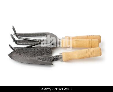 set of shovels, rakes and a view with a wooden handle for the garden isolated on white background Stock Photo