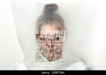 Portrait of teenage girl wearing  transparent mask with QR Code Stock Photo