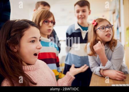 Children learning on a computer in classroom Stock Photo