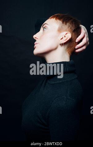 Young ginger serious woman thinking and looking aside isolated over ...