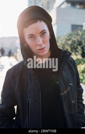 Portrait of cool young woman in the city at sunset Stock Photo