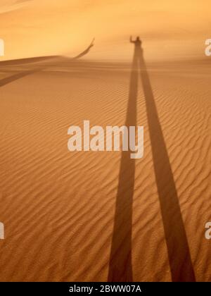 Shadow of a man and a woman on the desert sand, Walvis Bay, Namibia Stock Photo