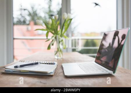 Laptop and notbooks on table in home interior Stock Photo