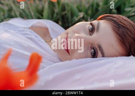 Portrait of smiling woman relaxin g in nature Stock Photo