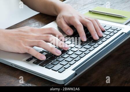 Man is typing on laptop keyboard. Stock Photo