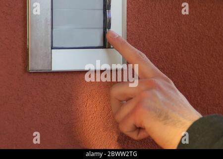 Man hand using intercom Stock Photo