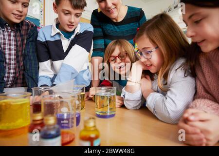 Group of children with teacher in a science chemistry lesson Stock Photo