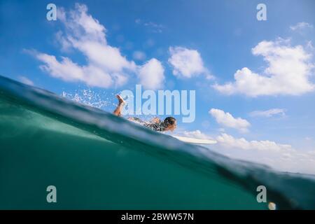 Woman surfing in the sea, Bali, Indonesia Stock Photo