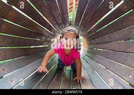 Portrait of happy little girl having fun on playground
