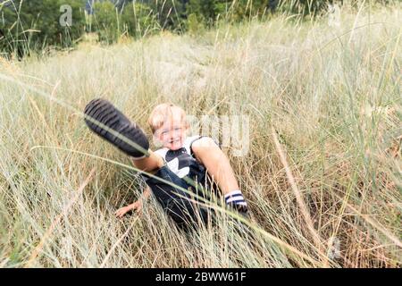 Portrait of smiling boy playing on a meadow Stock Photo